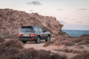 Explore the rugged beauty of Libya with this Toyota Land Cruiser off-road near the picturesque coastline.